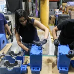 Elena Gómez and Simón Zuloaga at ABS assembling couplings