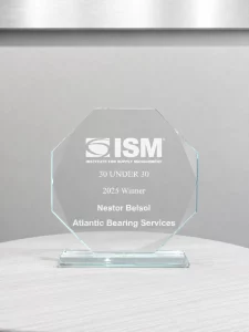 Glass award from ISM recognizing Nestor Belsol of Atlantic Bearing Services as a 2025 30 Under 30 winner