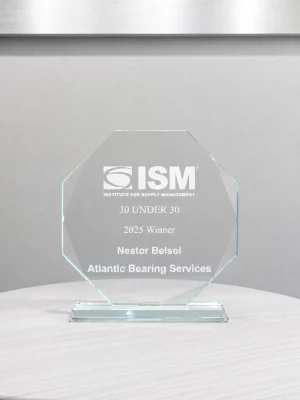 Glass award from ISM recognizing Nestor Belsol of Atlantic Bearing Services as a 2025 30 Under 30 winner