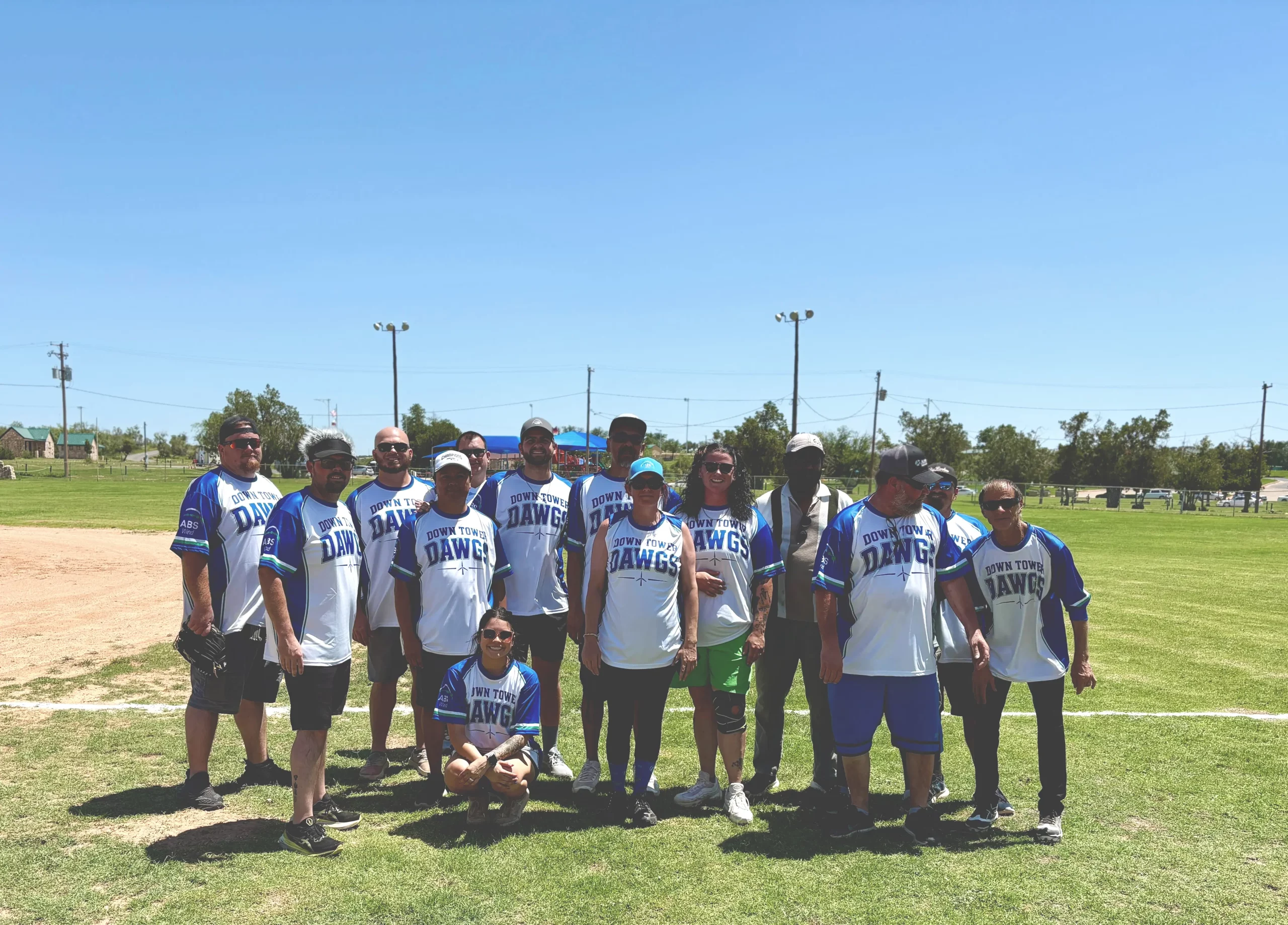 ABS Wind Big Spring employees and their families gathered on a softball field during a company team-building and family event in Texas.