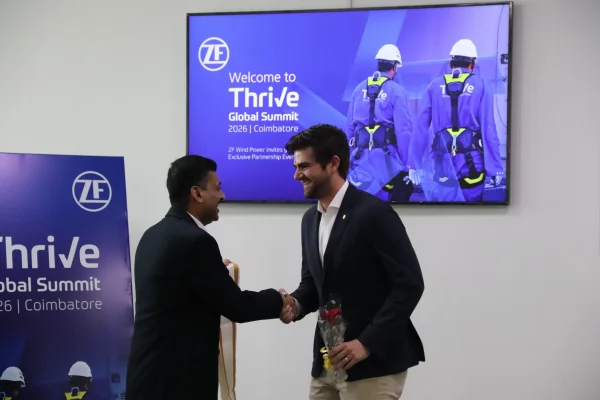 Sivakumar Jayapal presents a traditional ceremonial shawl to Alejandro Pardiñas Jr. during the ZF Wind Power Thrive Global Summit 2026.