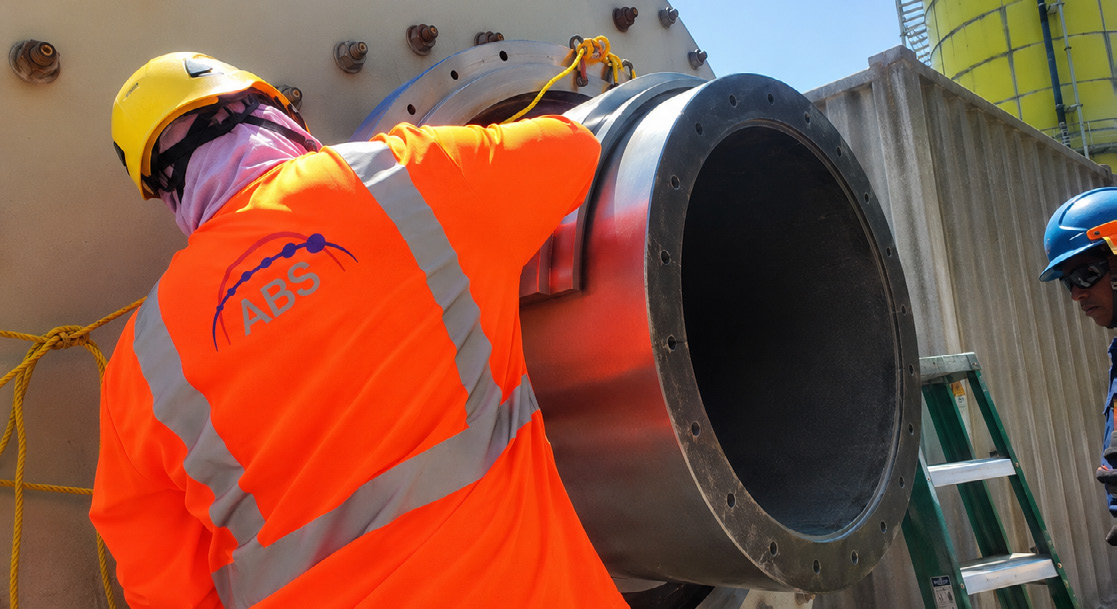 ABS field technician working on the bearing support system of a Plug&Grind XL cement mill