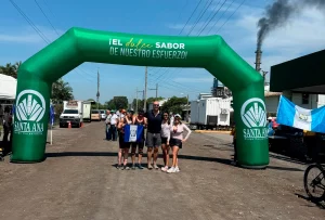 ABS team posing with a Guatemalan flag beneath the green Santa Ana arch at the 2026 sporting event.